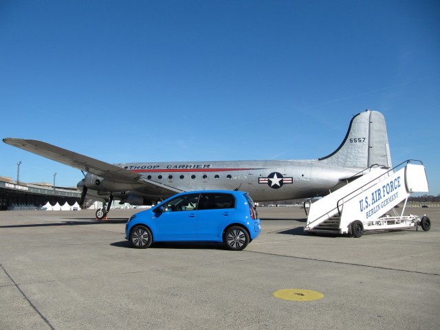 Volkswagen e-Up electric car with Douglas C54 transport plane at Berlin's Tempelhof Airport Volkswagen e-Up electric car with Douglas C54 transport plane at Berlin's Tempelhof Airport
