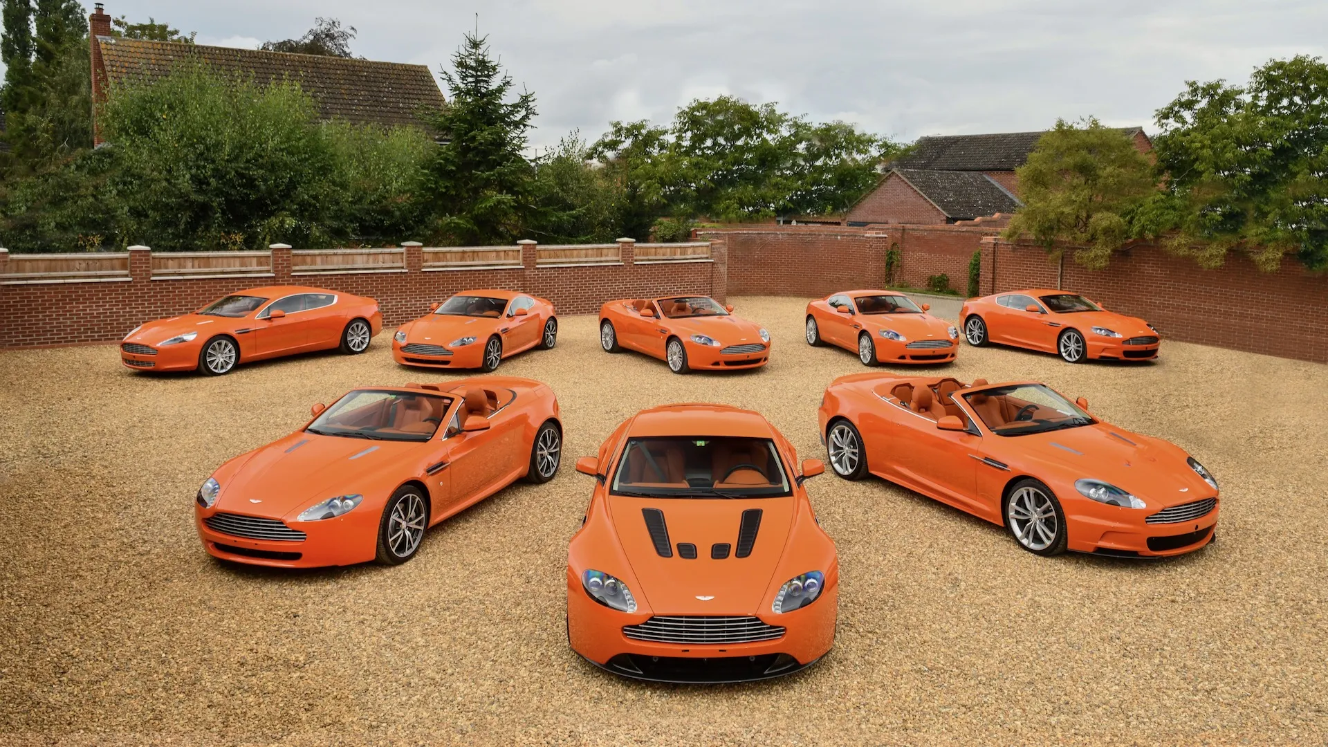 Assortment of 8 orange Aston Martins head to the public sale