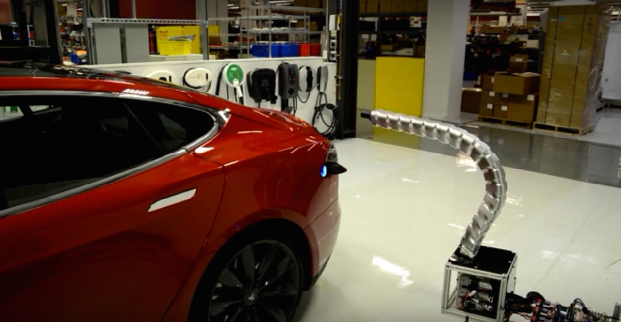 tesla releases video of snake like charger plugging into electric car automatically