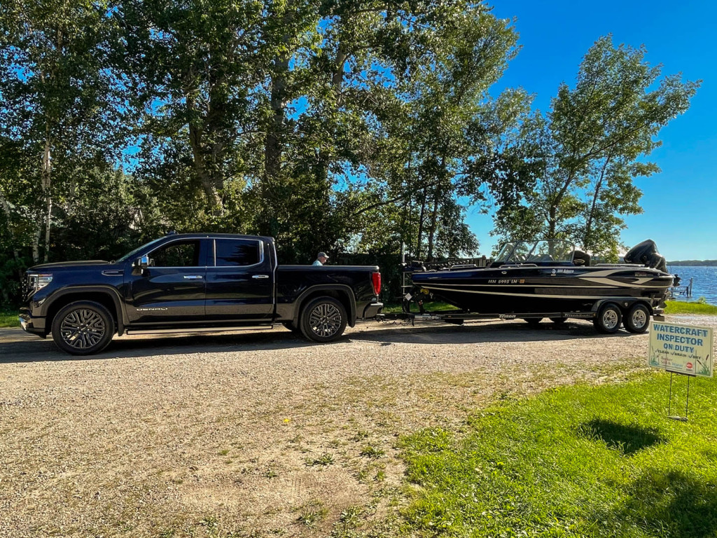 2022 GMC Sierra 1500 Denali Ultimate with a 20ft fiberglass walleye boat attached to it