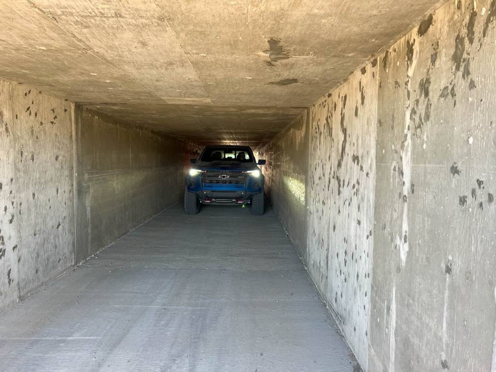 2023 Chevrolet Colorado ZR2 eases its way though a water drainage tunnel under the highway