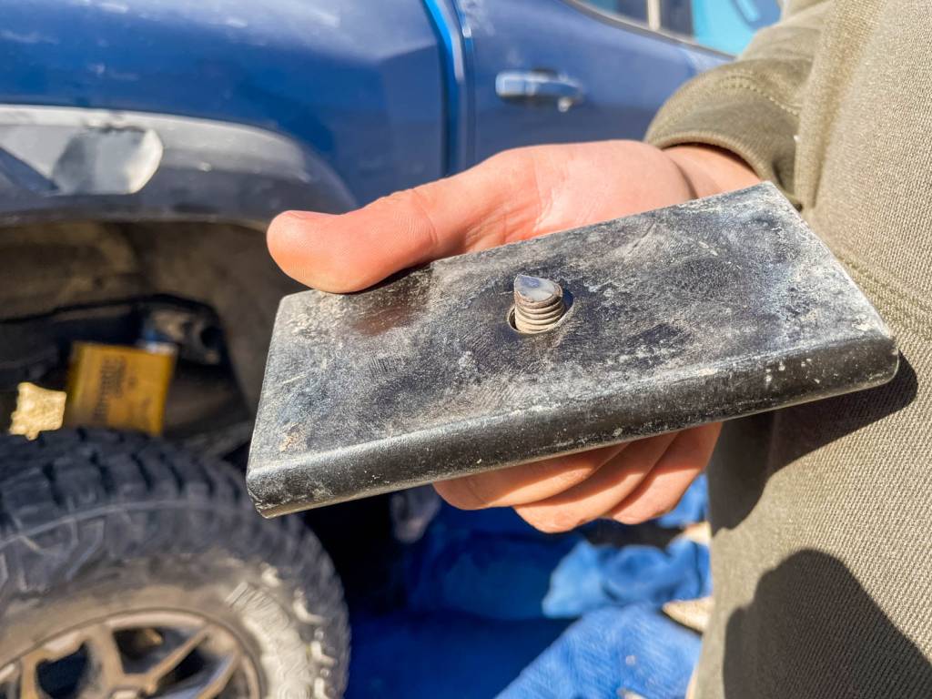 The rock had knocked the rear U-bolt off the top plate after shearing off the centering pin