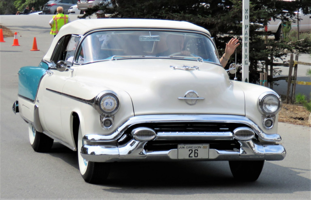 An Oldsmobile convertible on the road