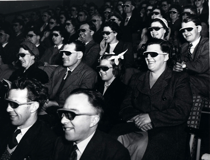 Audience wearing special glasses watch a 3D 'stereoscopic film' (UK National Archives)