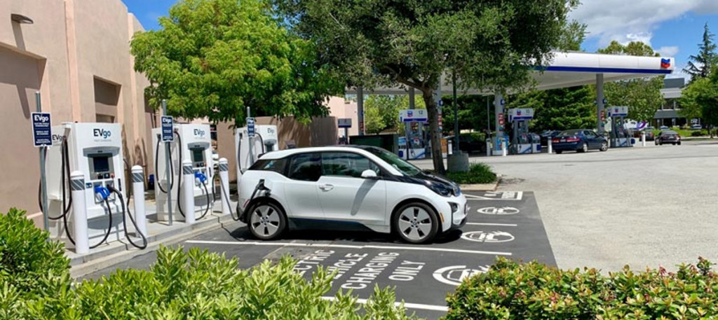 A BMW i3 is charging at EVgo fast chargers at a Chevron station in Menlo Park, California