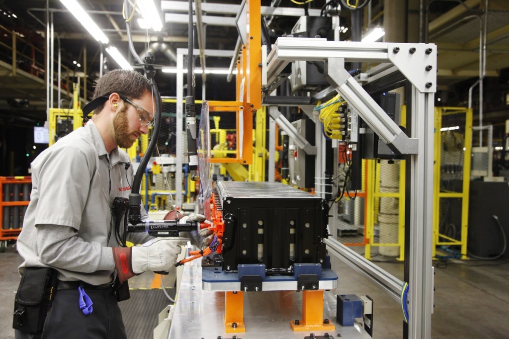 Technician attaches bus-bars to lithium-ion cell stack assembly at plant in Smyrna, Tennessee