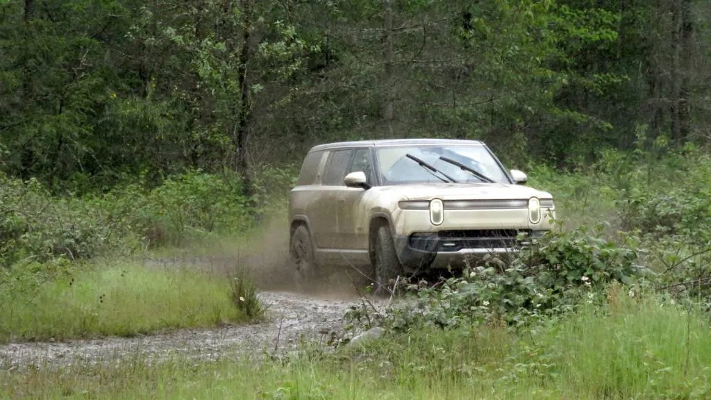 Rivian R1S in the mud, at DirtFish