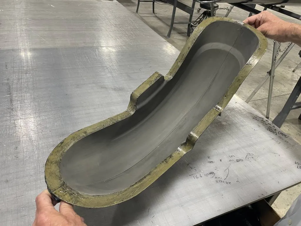 Carbon-fiber parts are created by first creating a master or plus, then making a mold off of it, laying in the carbon fiber, then trimming it.