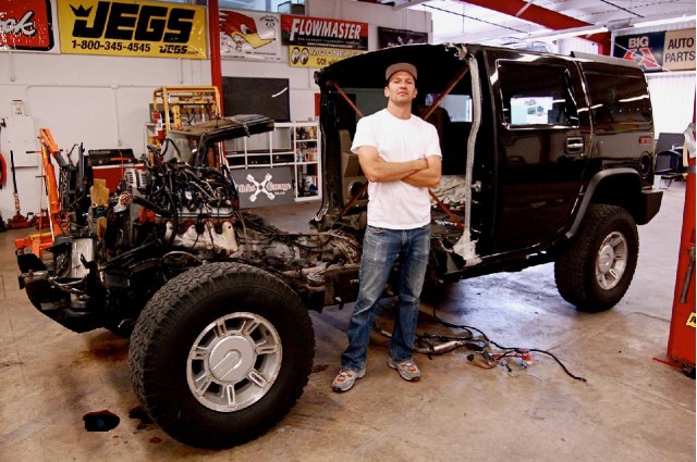 Artist Jeremy Dean with half a Hummer H2 for his work, 