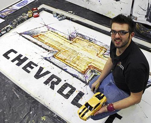 British artist Ian Cook with his painting of the Chevrolet bow-tie logo