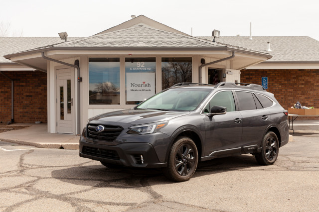 A 2020 Subaru Outback is shown outside of Nourish Meals on Wheels in Englewood, Colorado.