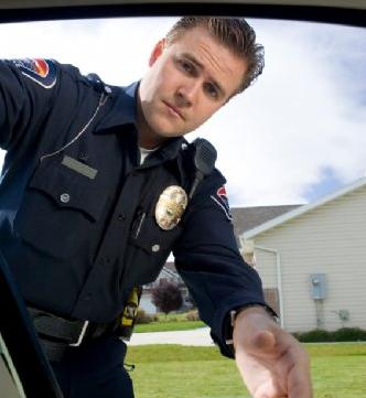 policeman reaching into car