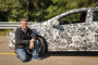 Chief engineer Andrew Farah with camouflaged 2016 Chevrolet Volt prototype